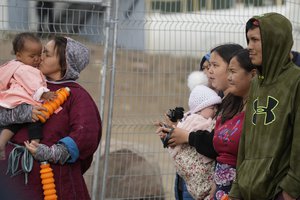 People wait a meeting with Pope Francis at Nakasuk Elementary School Square in Iqaluit, Canada, Friday, July 29, 2022.