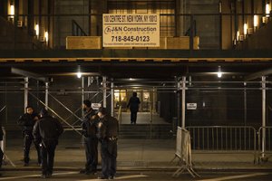 Police officers stand outside Manhattan Criminal Court in New York, Thursday, March 30, 2023.