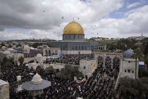 Muslim worshippers perform Friday prayers outside the Dome of Rock Mosque at the Al-Aqsa Mosque compound in the Old City of Jerusalem during the Muslim holy month of Ramadan, Friday, March 31, 2023.