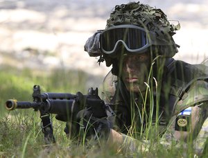 FILE - A Finnish soldier participates in the amphibious operations as part of NATO sea exercises BALTOPS 2015 in Ustka, Poland, on June 17, 2015. NATO Secretary-General Jens Stoltenberg said Monday Finland will become the 31st member of the world's biggest military alliance on Tuesday, prompting a warning from Russia that it would bolster its defenses near their joint border if NATO deploys any troops in its new member.