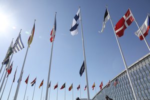 Military personnel raise the flag of Finland during a flag raising ceremony on the sidelines of a NATO foreign ministers meeting at NATO headquarters in Brussels, Tuesday, April 4, 2023