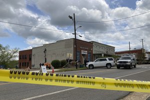 Investigators work at the site of a fatal shooting in downtown Dadeville, Ala., on Sunday, April 16, 2023.