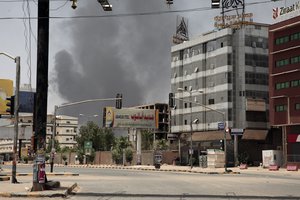 Smoke is seen rising from a neighborhood in Khartoum, Sudan, Saturday, April 15, 2023.