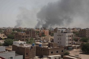 Smoke rises from a central neighborhood of Khartoum, Sudan, Sunday, April 16, 2023