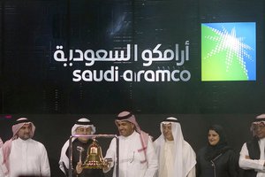 FILE - In this Dec. 11, 2019, file photo, Saudi Arabia's state-owned oil company Aramco and stock market officials celebrate the debut of Aramco's initial public offering on the Riyadh Stock Market, in Riyadh, Saudi Arabia.