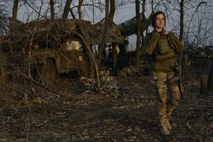 A Ukrainian soldier looks on from their position on the frontline in Bakhmut, Donetsk region, Ukraine, Wednesday, March 22, 2023