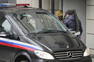 Reporter for the Wall Street Journal Evan Gershkovich is escorted by officers from the Lefortovsky court to a bus, in Moscow, Russia, Thursday, March 30, 2023