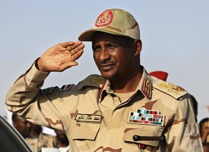 File - Gen. Mohammed Hamdan Dagalo, the deputy head of the military council that assumed power in Sudan after the overthrow of President Omar al-Bashir, salutes during a rally, in Galawee town, north of Sudan, Saturday, June 15, 2019.