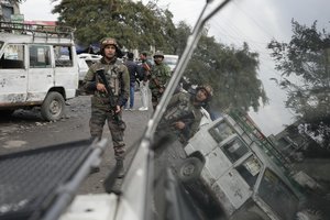 Indian army soldiers search an explosion site at Narwal area in Jammu, India, Saturday, Jan. 21, 2023.