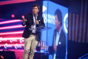 Tucker Carlson speaking with attendees at the 2022 AmericaFest at the Phoenix Convention Center in Phoenix, Arizona