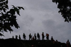 Rescuers search for victims in an area hit by an earthquake-triggered landslide in Cianjur, West Java, Indonesia, Saturday, Nov. 26, 2022.