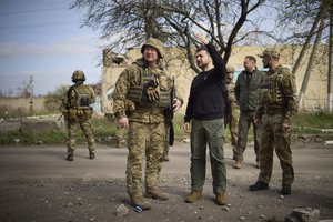 In this photo provided by the Ukrainian Presidential Press Office, Ukrainian president Volodymyr Zelenskyy talks with a commander at a position in Avdiivka, Donetsk region, Ukraine, Tuesday, April 18, 2023.