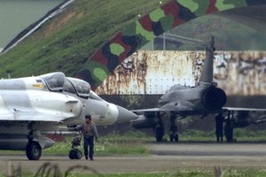 In this image made from video, a crew member gives a final check on a mirage fighter jet before taking off at an air base in Hsinchu, Taiwan, Thursday, April 6, 2023