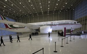 Mexican President Andres Manuel Lopez Obrador, center left, waves to the press as he arrives to give his daily, morning press conference