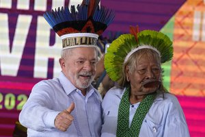 Brazilian President Luiz Inacio Lula da Silva gives a thumbs up after receiving a traditional Indigenous headdress from Cacique Caiapo, Raoni Metuktire, during the closing of the annual Terra Livre, or Free Land Indigenous Encampment in Brasilia, Brazil, Friday, April 28, 2023.