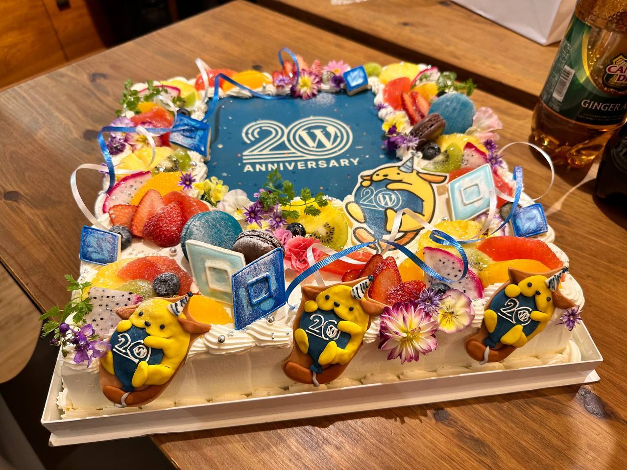 This image shows a cake with lots of WordPress-themed decorations on top of it. 