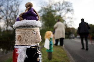 A knitted figure of Britain's King Charles III covers a post following its placement by members of the 'Hurst Hookers' knitting group during a pre-coronation 'yarn bombing' in the village of Hurst, near Reading, England, Friday, April 21, 2023.