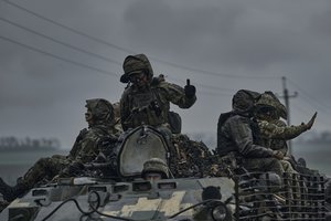 Ukrainian servicemen ride atop by an APC towards frontline positions near Vuhledar, Donetsk region, Ukraine, Monday, May 1, 2023