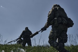 Ukrainian army snipers change their position facing Russian troops near Bakhmut, Donetsk region, Ukraine, Tuesday, May 2, 2023.