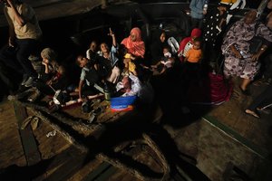 Sudanese evacuees wait at Port Sudan before boarding a Saudi military ship to Jeddah port, late Tuesday, May 2, 2023