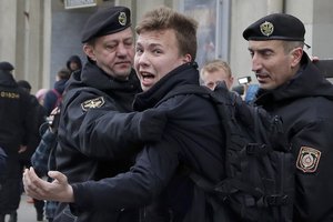 In this March 26, 2017, file photo, police detain journalist Raman Pratasevich, center, in Minsk, Belarus