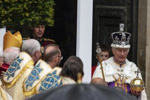 Britain's King Charles III departs Westminster Abbey after his coronation ceremony in London Saturday, May 6, 2023.