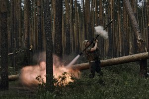 A Ukrainian soldier fires an RPG toward Russian positions at the frontline near Kremenna in the Luhansk region, Ukraine, Tuesday, May 9, 2023.