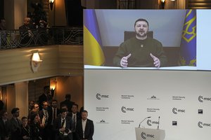 FILE - President Volodymyr Zelenskyy of Ukraine speaks from a screen at the Munich Security Conference in Munich, Germany, Friday, Feb. 17, 2023. Germany said Saturday, May 13, 2023, it is providing Ukraine with additional military aid worth more than 2.7 billion euros ($3 billion), including tanks, anti-aircraft systems and ammunition. The announcement Saturday came as preparations were underway in Berlin for a possible first visit to Germany by Ukrainian President Volodymyr Zelenskyy since Russia invaded his country last year.