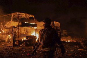 In this photo provided by the Ukrainian Emergency Situations Ministry, firefighters put out fire caused by fragments of a Russian rocket after it was shot down by air defense system during the night Russian rocket attack in Kyiv, Ukraine, early Tuesday, May 16, 2023