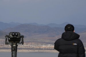 A visitor watches the North Korea side from the observation post in Ganghwa, near the border with North Korea, South Korea