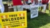 FILE - Signs are displayed at a tent during a health event on June 26, 2021, in Charleston, West Virginia. 