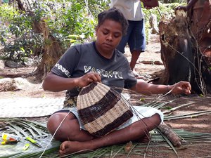 In remote Vetimboso Village, Victoria is meticulously preparing her signature handmade ‘half-moon’ cane basket, Vanuatu