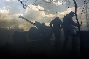 Ukrainian soldiers fire a cannon near Bakhmut, an eastern city where fierce battles against Russian forces have been taking place, in the Donetsk region, Ukraine, Friday, May 12, 2023