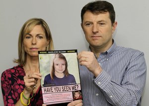 Kate and Gerry McCann pose for the media with a missing poster depicting an age progression computer generated image