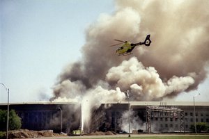 A helicopter flies over the Pentagon in Washington as smoke billows over the building on Sept. 11, 2001