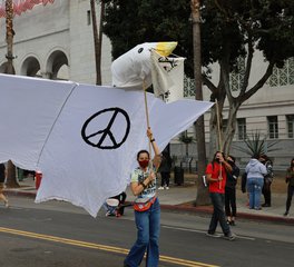 People Walking on Pedestrian Lane with Black Lives Matter flag