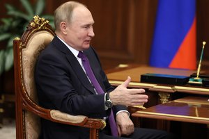 Russian President Vladimir Putin gestures speaking to the Chairman of the Supreme Court Vyacheslav Lebedev at the Kremlin in Moscow, Russia, Tuesday, Nov. 29, 2022