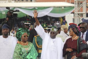 Nigeria's new President Bola Ahmed Tinubu, inspects honour guards after taking an oath of office at a ceremony in Abuja Nigeria, Monday May 29, 2023