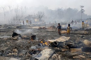 File - Rohingya refugee boys salvage a gas cylinder after a major fire in Balukhali camp at Ukhiya in Cox's Bazar district, Bangladesh, Sunday, March 5, 2023.