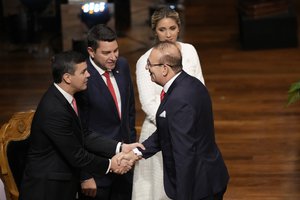 Santiago Peña, left, shakes hands with Senator-elect Erico Galeano during the electoral proclamation ceremony in Asuncion, Paraguay