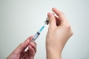 A nurse filling a syringue with the influenza vaccine at Air France's international vaccination centre