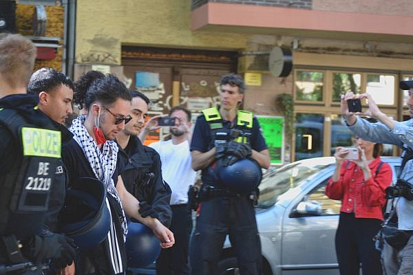 Berlin police arrest a Palestinian protester during a Nakba Day flash mob, after banning all commemorations of the day in the city, May 1, 2022. (@thequestionislysh)