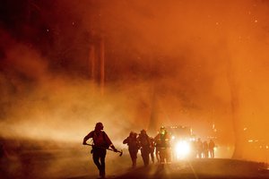 FILE - Firefighters battle the Mosquito Fire burning on Michigan Bluff Rd. in unincorporated Placer County, Calif., on Wednesday, Sept. 7, 2022.