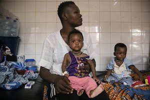 FILE- Malnourished children wait for treatment in the pediatrics department of Boulmiougou hospital in Ouagadougou, Burkina Faso, on April 15, 2022. Hunger is soaring and spreading across West Africa, with some 48 million people, a 10-year-high, facing food insecurity in the conflict-riddled region