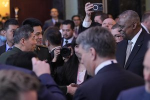 U.S. Defense Secretary Lloyd Austin III, right, shake hands with China Defense Minister Li Shangfu, left