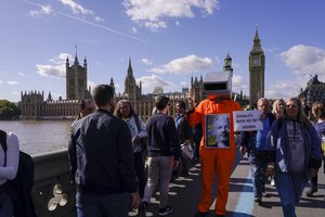 File - People take part to a protest in support of Julian Assange, against his extradition to the US, in London, Saturday, Oct. 8, 2022.