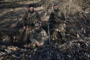 Ukrainian soldiers of the 28th brigade gather in a trench near Russian positions close to Bakhmut, Donetsk region, Ukraine, Monday, March 27, 2022