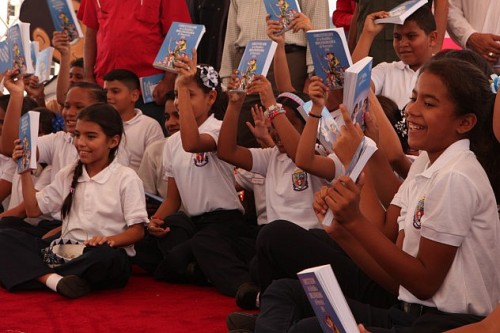 Venezuelan children with illustrated copies of 1999 Constitution, distributed to all schools.