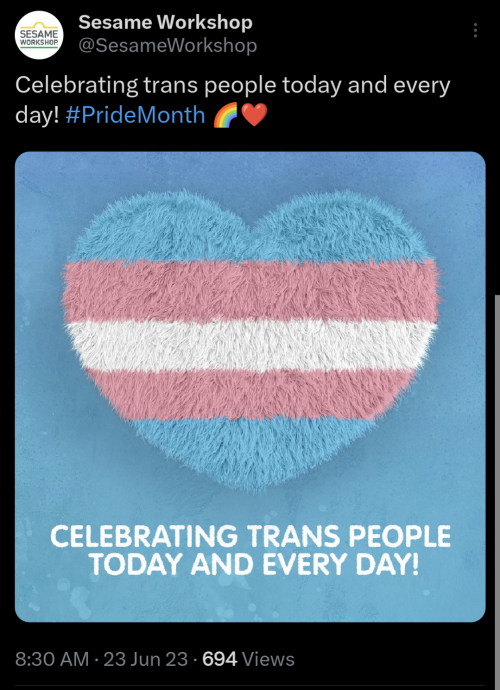 A tweet by the sesame Street account posted June 23rd 2023, with the caption "celebrating trans people today and every day #pridemonth" with an image that reads the same featuring a fuzzy heart with the trans flag colors on it