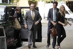 Actor Kevin Spacey, second left, arrives with some of his legal team at Southwark Crown Court in London, Friday, June 30, 2023